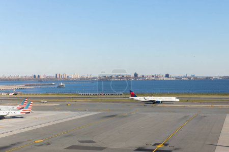 Photo for Queens, NY, USA - December 12, 2023: The LaGuardia Airport port runway with a "Welcome to New York" sign and a Delta Airlines plane taking off. - Royalty Free Image