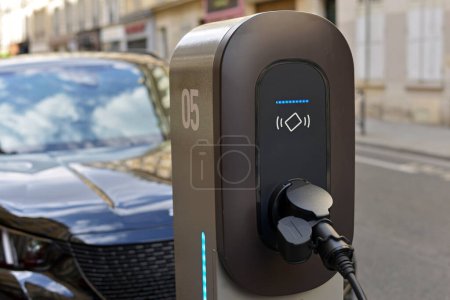 Photo for Power supply connected to electric car. Charging technology industry - Royalty Free Image