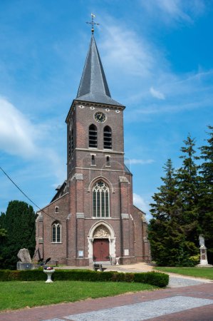 Photo for Grimbergen, Flemish Brabant, Belgium, June 30, 2023 - Catholic church of the village against blue sky - Royalty Free Image