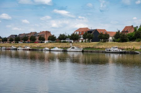 Photo for Grimbergen, Flemish Brabant, Belgium, June 30, 2023 -  Small vessels at the banks of the canal with traditional residential houses - Royalty Free Image