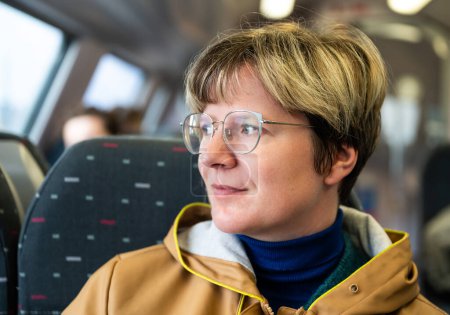 Photo for 37 yo white woman with glasses, sitting on a train, Tienen, Flanders, Belgium - Royalty Free Image