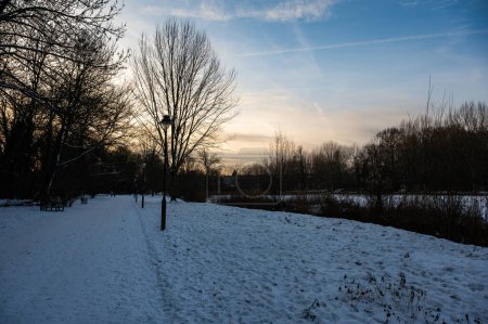 Walking path through the meadows, covered with snow in