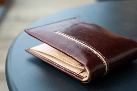 Brown leather wallet for men on a table, Brussels, Belgium