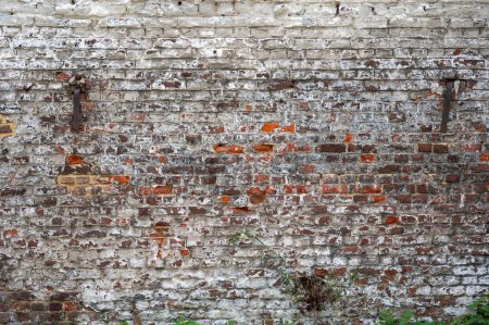 Dirty brick stone wall with mortar layers, textured background in Brussels Belgium