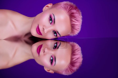 Photo for Professional lighting studio photo bright makeup woman posing above mirror glass reflection pink magenta violet colors. - Royalty Free Image