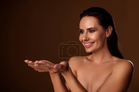Photo for Photo of gorgeous model lady hold open palms arms advice beauty product salon offer isolated brown background. - Royalty Free Image