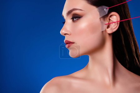 Photo for Profile side photo of stunning lady on cosmetician visit apply face lifting anti aging procedure on blue background. - Royalty Free Image