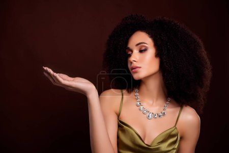 Photo for Photo of attractive dream lady jewel shop assistant present luxurious pendants on dark brown color background. - Royalty Free Image