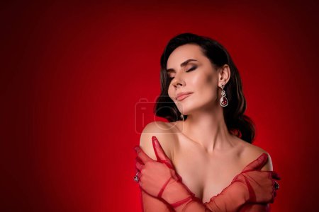 Photo for Studio portrait of amazing confident lady embrace herself wear transparent red lace long gloves close eyes from joy. - Royalty Free Image
