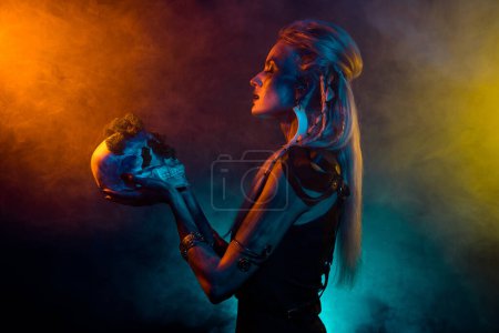 Photo for Photo of adorable attractive mystic woman wear gothic valkyrie costume praying skull isolated fog background. - Royalty Free Image