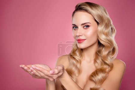 Photo for Photo of chic stunning lady hold beauty promo demonstrate salon adverts on pastel empty space isolated. - Royalty Free Image