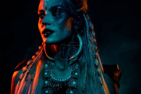Photo for Photo of attractive wild mystic woman wear gothic valkyrie costume isolated dark orange color background. - Royalty Free Image