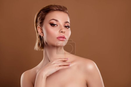 Photo for Photo of smiling sweet woman naked shoulders arm touch neck empty space isolated beige color background. - Royalty Free Image
