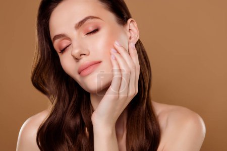 Photo for Portrait of pretty girl touch cheeks enjoy fresh skin after peeling cleansing collagen on pastel color background. - Royalty Free Image