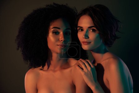 Photo for Photo of luxury adorable ladies nude shoulders smiling embracing isolated dark color background. - Royalty Free Image