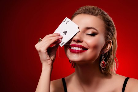 Photo for Photo of stunning woman wear black dress playing cards close eye empty space isolated red ruby color background. - Royalty Free Image