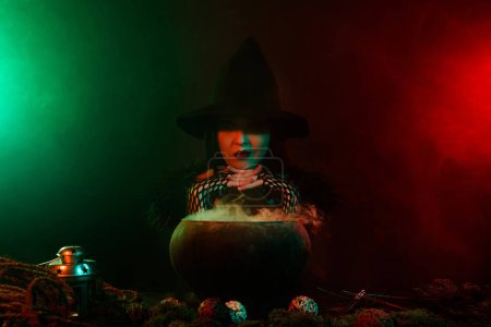 Photo for Photo of evil dark witch prepare poisonous potion in cauldron powerful ritual for summon satan on halloween. - Royalty Free Image