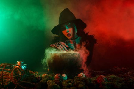 Photo for Photo of stunning lady powerful witch wicca making love potion look in future in mist neon background. - Royalty Free Image