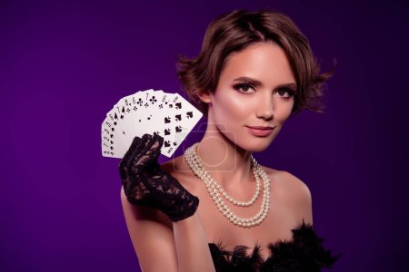 Photo for Photo of wealthy noble lady in night club playing poker on vintage event occasion over purple background. - Royalty Free Image
