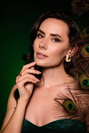 Photo for Photo of adorable stunning lady holding peacock feather isolated black color background. - Royalty Free Image