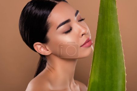 Photo for Photo of adorable lady herbal cosmetics green fresh aloe leaf natural cream lotion isolated on beige color background. - Royalty Free Image