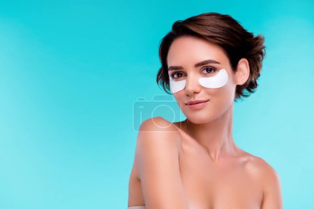 Photo for Photo of pretty lovely girl gentle tender applying patches with collagen gel for soft skin over blue color background. - Royalty Free Image
