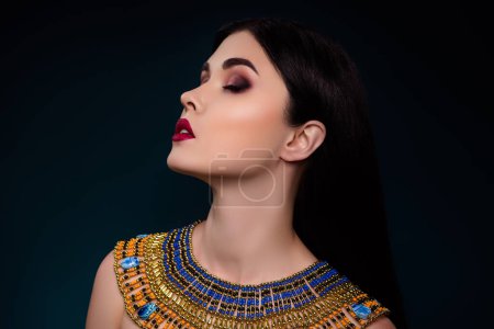Photo for Photo of rich lady egyptian royalty enjoying true cleopathra beauty isolated over dark color background. - Royalty Free Image