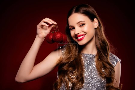 Photo for Photo of chic stunning girl hold baubles for decorating interior prepare christmas event over maroon background. - Royalty Free Image