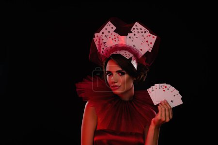 Photo for Studio photo of young stunning woman casino night dealer wear casino vintage gown isolated red light black background. - Royalty Free Image
