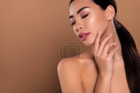 Photo for Photo of adorable cute gentle girl hand touch soft skin cleansing mask lotion isolated on beige color background. - Royalty Free Image