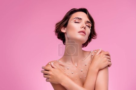 Photo for Photo of stunning gorgeous lady hug herself afterorganic therapy with pearls ingredient balm. - Royalty Free Image