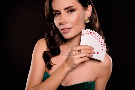 Foto de Foto de señora elegante jugador de póquer profesional ganar hacer flash combinación real sobre fondo de color oscuro. - Imagen libre de derechos
