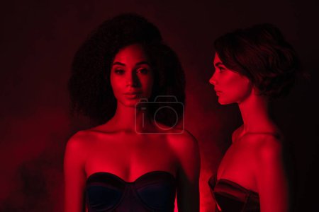 Photo for Photo of pretty lovely girlfriends celebrate futuristic event in nightclub over mist neon effect background. - Royalty Free Image