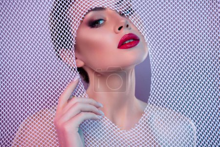 Photo for Photo of lovely sexy woman nude shoulders trying escape fabric net isolated violet color background. - Royalty Free Image