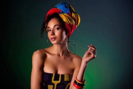 Photo for Photo of chic elegant lady on luxurious africa cultural festival flirt with rich tourists over dark background. - Royalty Free Image