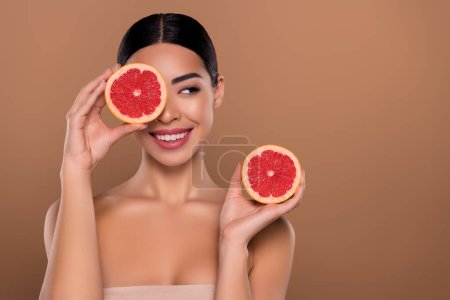Photo for Portrait of lady hold half grapefruit enjoying self care hygiene look empty space isolated on beige color background. - Royalty Free Image