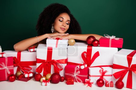 Photo for Photo of stunning chic lady advertise many gift box prepare for christmas new year celebration over green background. - Royalty Free Image