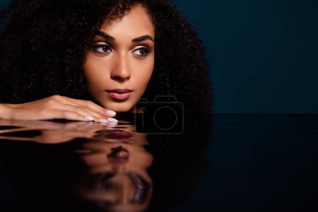 Photo for Portrait of stunning lady relaxing enjoying hydration procedure in dark aesthetic bathroom with clear water. - Royalty Free Image