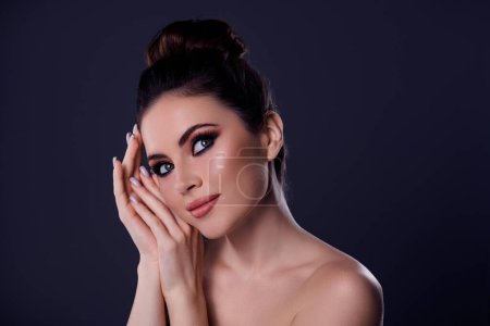 Photo for Photo of dreaming lady touch face with glamorous makeup at high fashion party isolated on dark color background. - Royalty Free Image