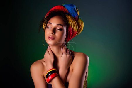 Téléchargez les photos : Photo de dame esthétique kenya tribu reine yeux fermés en transe parler avec des ancêtres sur fond de couleur sombre. - en image libre de droit
