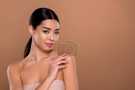 Photo for Photo of tender beauty model touching hand shoulder posing like hollywood star isolated on beige color background. - Royalty Free Image