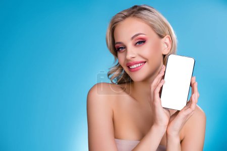 Photo for Photo of feminine attractive girl electronics store promoter showing new cell smart device model over blue background. - Royalty Free Image
