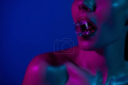 Photo for Cropped photo of alluring lady bite cold ice cube cryo therapy procedure over vivid background. - Royalty Free Image