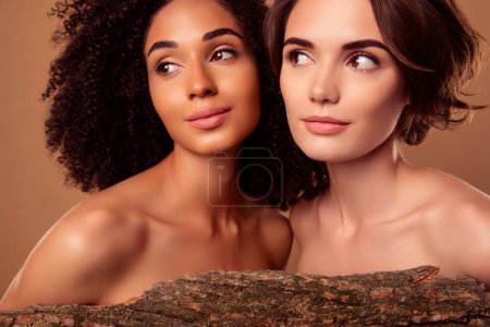 Foto de Photo of two people girls advertising new beauty technology apply treatment with organic tree extract. - Imagen libre de derechos