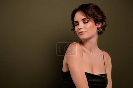 Photo for Photo of classy girlfriend with closed smoky eyes stand over green empty space background wearing style trend gown. - Royalty Free Image
