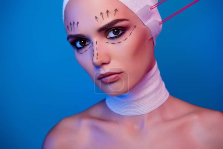 Photo for Photo of attractive girl with beauty correction marks on face have tape face lifting procedure over neon background. - Royalty Free Image