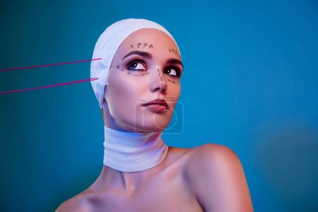 Photo for Photo of attractive charming girl in bandage having tape lifting look on blue neon color background. - Royalty Free Image