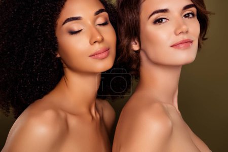 Photo for Portrait of two happy ladies closed eyes daily routine enjoy pampering procedures isolated on khaki color background. - Royalty Free Image