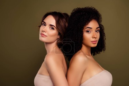 Photo for Portrait of two pretty women feminist seducing you to join lgbt community isolated over khaki color background. - Royalty Free Image