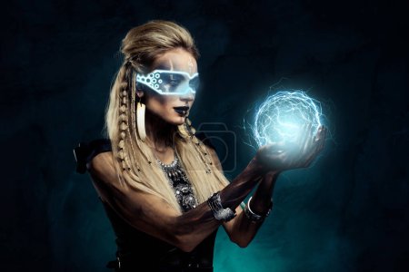 Foto de Collage creativo de señora usar gafas vr elegir personaje vikingo en el juego hacer magia holográfica sobre fondo negro. - Imagen libre de derechos